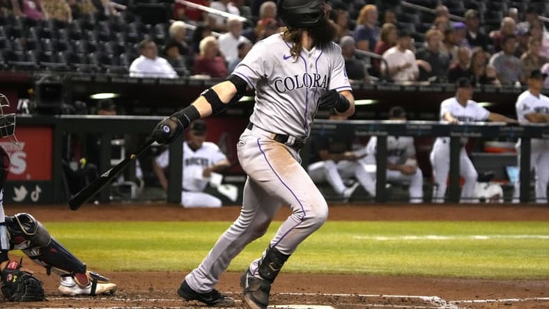Sep 5, 2023; Phoenix, Arizona, USA; Colorado Rockies designated hitter Charlie Blackmon (19) hits an RBI sacrifice fly out against the Arizona Diamondbacks in the fourth inning at Chase Field. Mandatory Credit: Rick Scuteri-USA TODAY Sports
