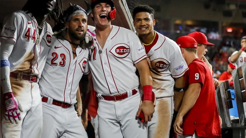 Sep 5, 2023; Cincinnati, Ohio, USA; Cincinnati Reds pinch hitter Nick Martini (23) reacts after hitting a three-run home run with shortstop Elly De La Cruz (44), pinch hitter Tyler Stephenson (37) and third baseman Noelvi Marte (16) in the eighth inning against the Seattle Mariners at Great American Ball Park. Mandatory Credit: Katie Stratman-USA TODAY Sports