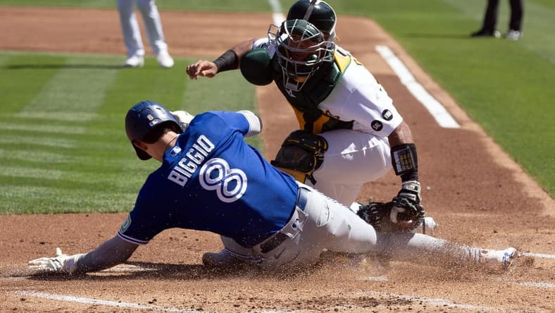 Sep 6, 2023; Oakland, California, USA; Toronto Blue Jays right fielder Cavan Biggio (8) scores a run against Oakland Athletics catcher Carlos P rez (44) during the second inning at Oakland-Alameda County Coliseum. Mandatory Credit: D. Ross Cameron-USA TODAY Sports