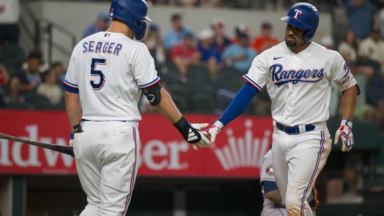 Sep 6, 2023; Arlington, Texas, USA; Texas Rangers shortstop Corey Seager (5) and second baseman Marcus Semien (2) celebrate after Semien hits a home run against the Houston Astros at Globe Life Field. Mandatory Credit: Jerome Miron-USA TODAY Sports