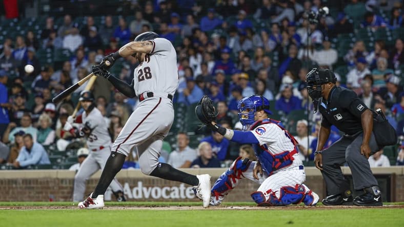 Sep 7, 2023; Chicago, Illinois, USA; Arizona Diamondbacks left fielder Tommy Pham (28) hits a solo home run against the Chicago Cubs during the first inning at Wrigley Field. Mandatory Credit: Kamil Krzaczynski-USA TODAY Sports