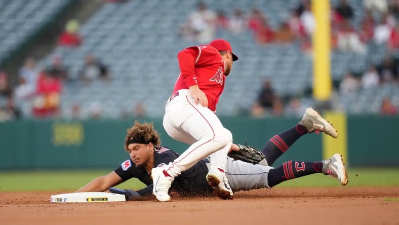 Sep 7, 2023; Anaheim, California, USA; Cleveland Guardians first baseman Josh Naylor (22) slides into second base to beat a throw to Los Angeles Angels second baseman Brandon Drury (23) in the first inning at Angel Stadium. Mandatory Credit: Kirby Lee-USA TODAY Sports