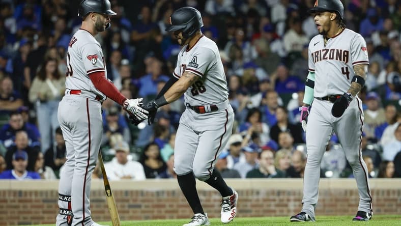 Sep 7, 2023; Chicago, Illinois, USA; Arizona Diamondbacks left fielder Tommy Pham (28) celebrates with first baseman Christian Walker (53) after hitting a two-run home run against the Chicago Cubs during the eight inning at Wrigley Field. Mandatory Credit: Kamil Krzaczynski-USA TODAY Sports