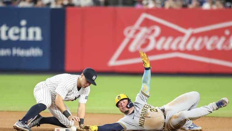 Sep 8, 2023; Bronx, New York, USA;   New York Yankees shortstop Anthony Volpe (11) drops the ball allowing Milwaukee Brewers catcher William Contreras (24) to steal second in the seventh inning at Yankee Stadium. Mandatory Credit: Wendell Cruz-USA TODAY Sports