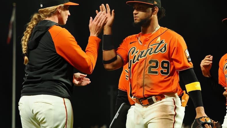 Sep 8, 2023; San Francisco, California, USA; San Francisco Giants major league coach Alyssa Nakken (92) high fives San Francisco Giants' Luis Matos (29) after a win against the Colorado Rockies at Oracle Park. Mandatory Credit: Kelley L Cox-USA TODAY Sports