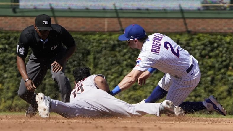 Sep 9, 2023; Chicago, Illinois, USA; Arizona Diamondbacks catcher Gabriel Moreno (14) steals second base as Chicago Cubs second baseman Nico Hoerner (2) makes a late tag during the third inning at Wrigley Field. Mandatory Credit: David Banks-USA TODAY Sports