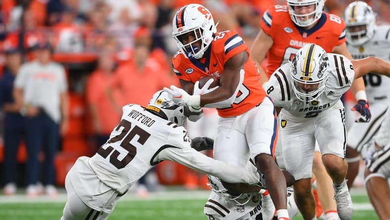 Sep 9, 2023; Syracuse, New York, USA; Syracuse Orange running back Juwaun Price (28) runs with the ball as Western Michigan Broncos cornerback Aaron Wofford (25) defends during the first half at the JMA Wireless Dome. Mandatory Credit: Rich Barnes-USA TODAY Sports