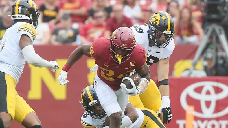 Iowa State Cyclones running back Abu Sama (24) breaks a tackle from Iowa Hawkeyes' defensive back Deshaun Lee (8) and Iowa Hawkeyes defensive line Yahya Black (94) during the second quarter of the Cy-Hawk football game at the Jack Trice Stadium on Saturday, Sept. 9, 2023, in Ames, Iowa.