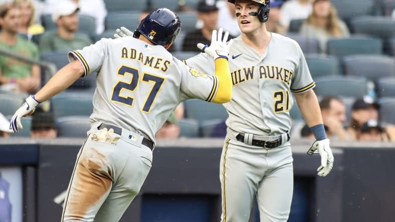 Sep 9, 2023; Bronx, New York, USA;  Milwaukee Brewers shortstop Willy Adames (27) is greeted by right fielder Mark Canha (21) after hitting an RBI triple and scoring on an error in the fourth inning against the New York Yankees at Yankee Stadium. Mandatory Credit: Wendell Cruz-USA TODAY Sports