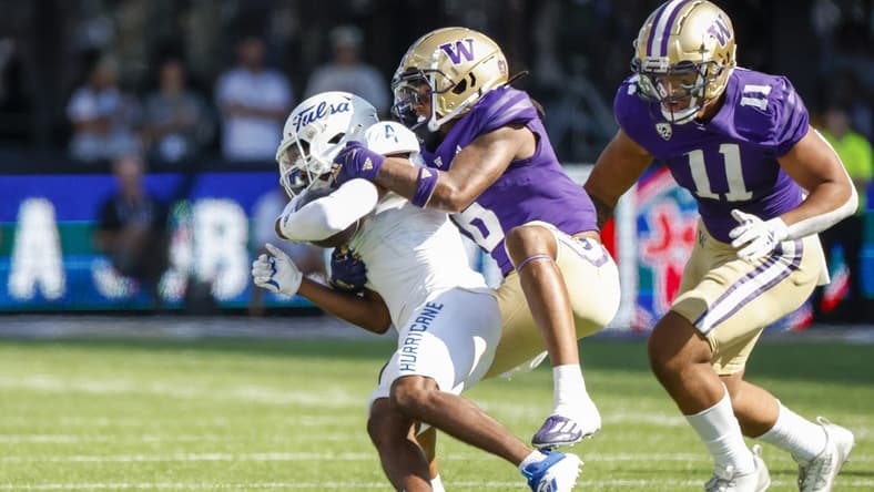 Sep 9, 2023; Seattle, Washington, USA; Washington Huskies cornerback Davon Banks (6) tackles Tulsa Golden Hurricane wide receiver Marquis Shoulders (4) following a second quarter reception at Alaska Airlines Field at Husky Stadium. Mandatory Credit: Joe Nicholson-USA TODAY Sports