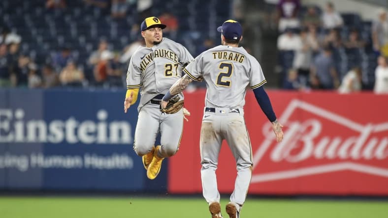 Sep 9, 2023; Bronx, New York, USA;  Milwaukee Brewers shortstop Willy Adames (27) and second baseman Brice Turang (2) celebrate after defeating the New York Yankees 9-2 at Yankee Stadium. Mandatory Credit: Wendell Cruz-USA TODAY Sports