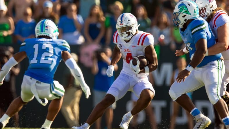 Sep 9, 2023; New Orleans, Louisiana, USA;  Mississippi Rebels running back Quinshon Judkins (4) rushes against Tulane Green Wave defensive back DJ Douglas (12) during the second half at Yulman Stadium. Mandatory Credit: Stephen Lew-USA TODAY Sports