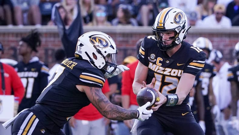 Sep 9, 2023; Columbia, Missouri, USA; Missouri Tigers quarterback Brady Cook (12) hands off to running back Cody Schrader (7) against the Middle Tennessee Blue Raiders during the first half at Faurot Field at Memorial Stadium. Mandatory Credit: Denny Medley-USA TODAY Sports