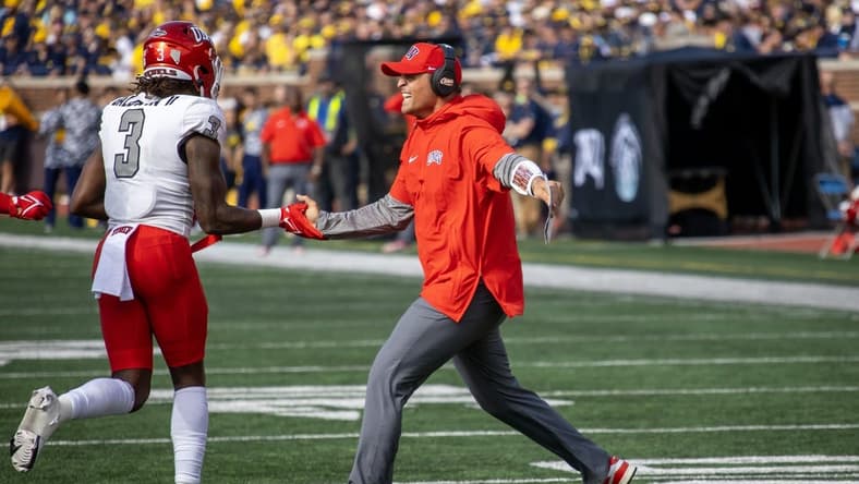 Sep 9, 2023; Ann Arbor, Michigan, USA; UNLV Rebels Defensive Coordinator/Linebackers Mike Scherer slaps hand with defensive back Johnathan Baldwin (3) after a fourth down stand against the Michigan Wolverines during the first half at Michigan Stadium. Mandatory Credit: David Reginek-USA TODAY Sports