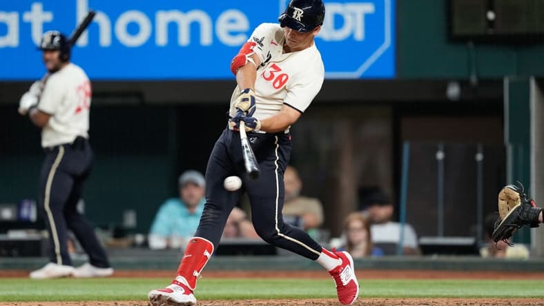 Sep 9, 2023; Arlington, Texas, USA; Texas Rangers first baseman Nathaniel Lowe (30) hits an RBI single against the Oakland Athletics during the sixth inning at Globe Life Field. Mandatory Credit: Jim Cowsert-USA TODAY Sports