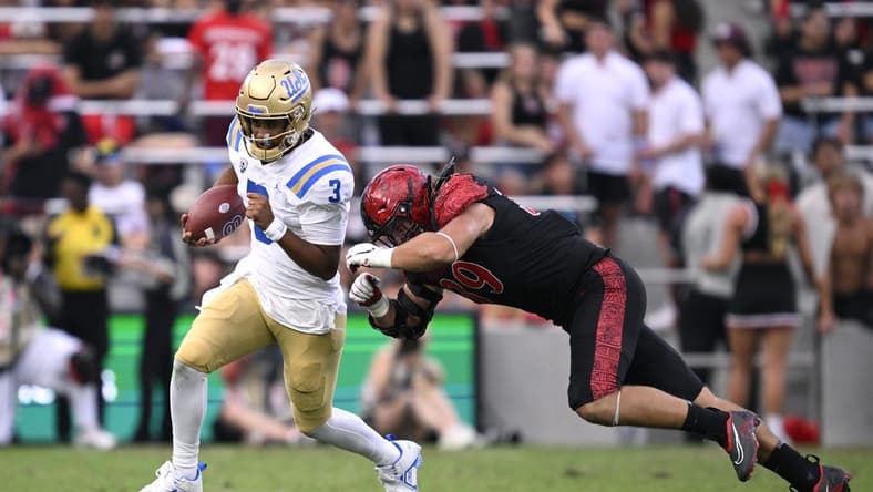Sep 9, 2023; San Diego, California, USA; UCLA Bruins quarterback Dante Moore (3) runs the ball while defended by San Diego State Aztecs defensive lineman Garret Fountain (39) during the first half at Snapdragon Stadium. Mandatory Credit: Orlando Ramirez-USA TODAY Sports