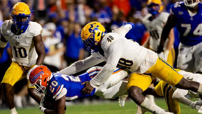 Sep 9, 2023; Gainesville, Florida, USA; Florida Gators running back Treyaun Webb (20) stretches for a first down tackled by McNeese State Cowboys linebacker Micah Davey (48) during the second half at Ben Hill Griffin Stadium. Mandatory Credit: Matt Pendleton-USA TODAY Sports