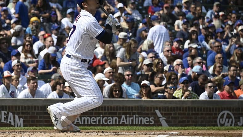 Sep 10, 2023; Chicago, Illinois, USA;  Chicago Cubs right fielder Seiya Suzuki (27) hits an RBI double against the Arizona Diamondbacks during the first inning at Wrigley Field. Mandatory Credit: Matt Marton-USA TODAY Sports