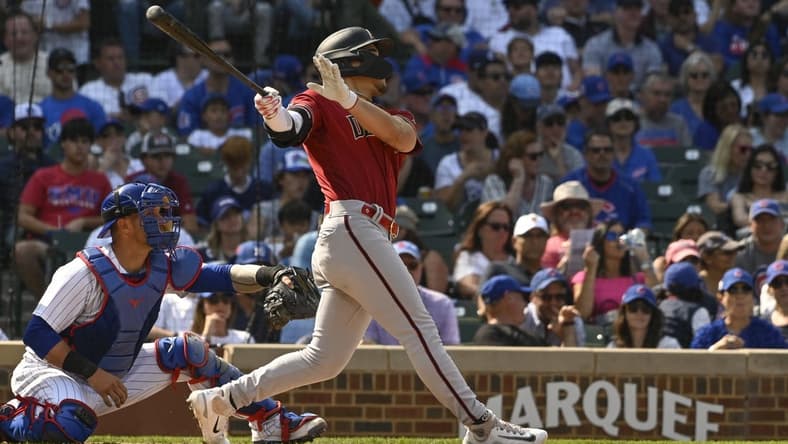 Sep 10, 2023; Chicago, Illinois, USA;  Arizona Diamondbacks center fielder Alek Thomas (5) hits an RBI sacrifice fly ball against the Chicago Cubs during the sixth inningat Wrigley Field. Mandatory Credit: Matt Marton-USA TODAY Sports