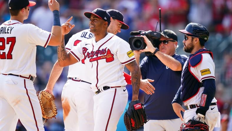 Sep 10, 2023; Cumberland, Georgia, USA; Atlanta Braves relief pitcher Raisel Iglesias (26) celebrates with Atlanta Braves third baseman Austin Riley (27) after winning 5-2 against the Pittsburgh Pirates at Truist Park. Mandatory Credit: John David Mercer-USA TODAY Sports
