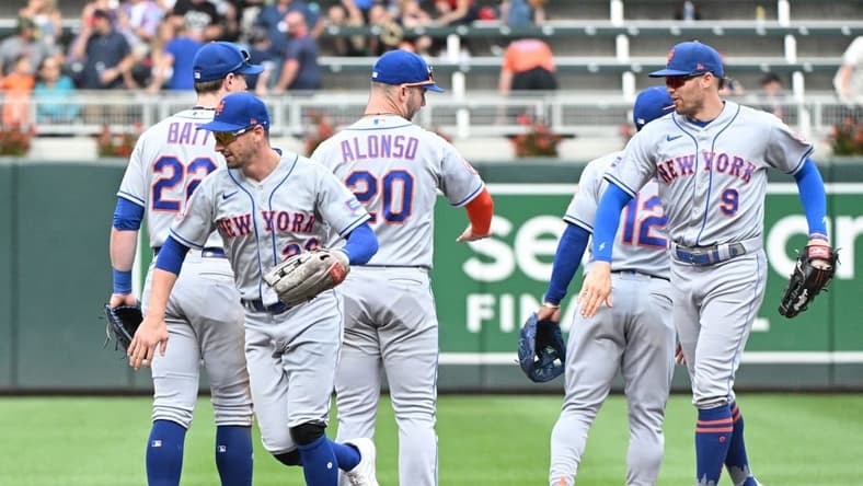 Sep 10, 2023; Minneapolis, Minnesota, USA; New York Mets left fielder Tim Locastro (26) and New York Mets center fielder Brandon Nimmo (9) celebrate a 2-0 win with their teammates at Target Field. Mandatory Credit: Michael McLoone-USA TODAY Sports