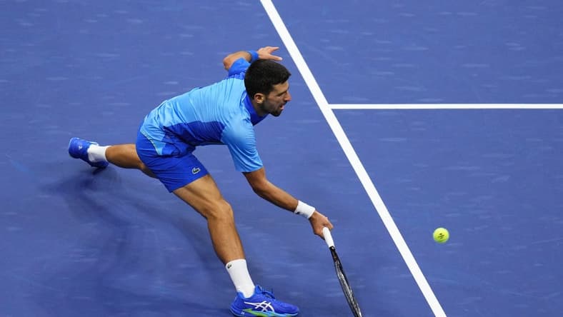 Sep 10, 2023; Flushing, NY, USA; Novak Djokovic of Serbia reaches for a forehand against Daniil Medvedev (not pictured) in the men's singles final in the men's singles final on day fourteen of the 2023 U.S. Open tennis tournament at USTA Billie Jean King National Tennis Center. Mandatory Credit: Danielle Parhizkaran-USA TODAY Sports