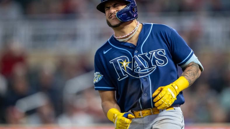 Sep 11, 2023; Minneapolis, Minnesota, USA; Tampa Bay Rays center fielder Jose Siri (22) reacts after getting hit in the hand by a pitch against the Minnesota Twins in the fifth inning at Target Field. Mandatory Credit: Jesse Johnson-USA TODAY Sports