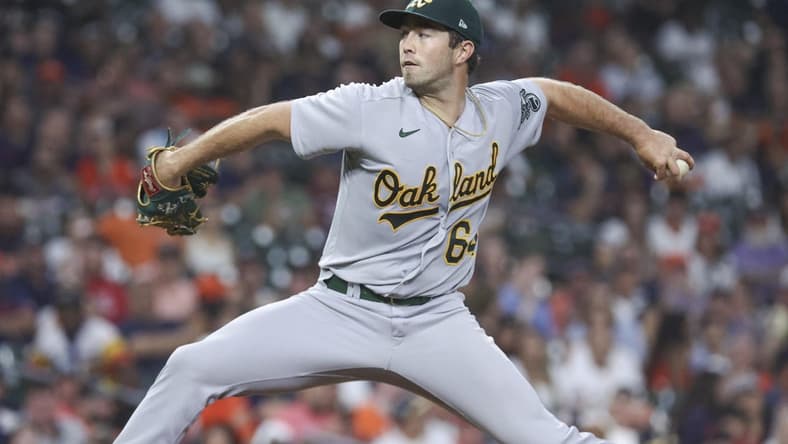 Sep 11, 2023; Houston, Texas, USA; Oakland Athletics relief pitcher Ken Waldichuk (64) delivers a pitch during the sixth inning against the Houston Astros at Minute Maid Park. Mandatory Credit: Troy Taormina-USA TODAY Sports