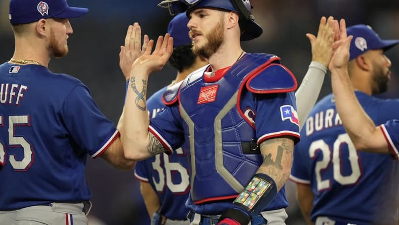 Sep 11, 2023; Toronto, Ontario, CAN; Texas Rangers catcher Jonah Heim (28) gets congratulated after a win over the Toronto Blue Jays at Rogers Centre. Mandatory Credit: John E. Sokolowski-USA TODAY Sports