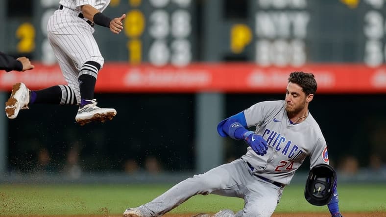 Sep 11, 2023; Denver, Colorado, USA; Chicago Cubs center fielder Cody Bellinger (24) slides into second on a double in the sixth inning against the Colorado Rockies at Coors Field. Mandatory Credit: Isaiah J. Downing-USA TODAY Sports