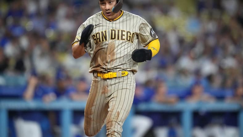 Sep 11, 2023; Los Angeles, California, USA; San Diego Padres second baseman Ha-Seong Kim (7) scores in the first inning against the Los Angeles Dodgers at Dodger Stadium. Mandatory Credit: Kirby Lee-USA TODAY Sports