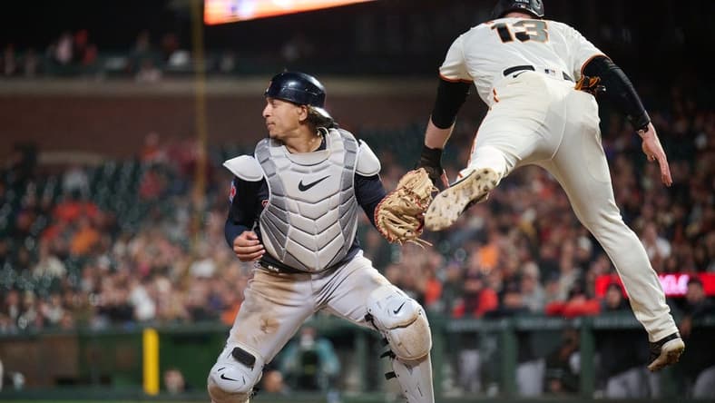 Sep 11, 2023; San Francisco, California, USA; San Francisco Giants outfielder Austin Slater (13) leaps after being tagged out by Cleveland Guardians catcher Bo Naylor (23) on a force play at home plate during the seventh inning at Oracle Park. Mandatory Credit: Robert Edwards-USA TODAY Sports