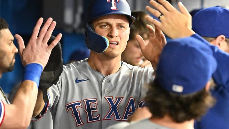 Sep 12, 2023; Toronto, Ontario, CAN;  Texas Rangers shortstop Corey Seager (5) celebrate with team mates in the dugout after scoring against the Toronto Blue Jays in the sixth inning at Rogers Centre. Mandatory Credit: Dan Hamilton-USA TODAY Sports