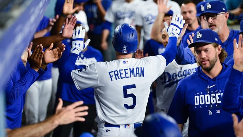 Sep 12, 2023; Los Angeles, California, USA; Los Angeles Dodgers first baseman Freddie Freeman (5) is greeted after hitting a two run home run against the San Diego Padres during the third inning at Dodger Stadium. Mandatory Credit: Gary A. Vasquez-USA TODAY Sports