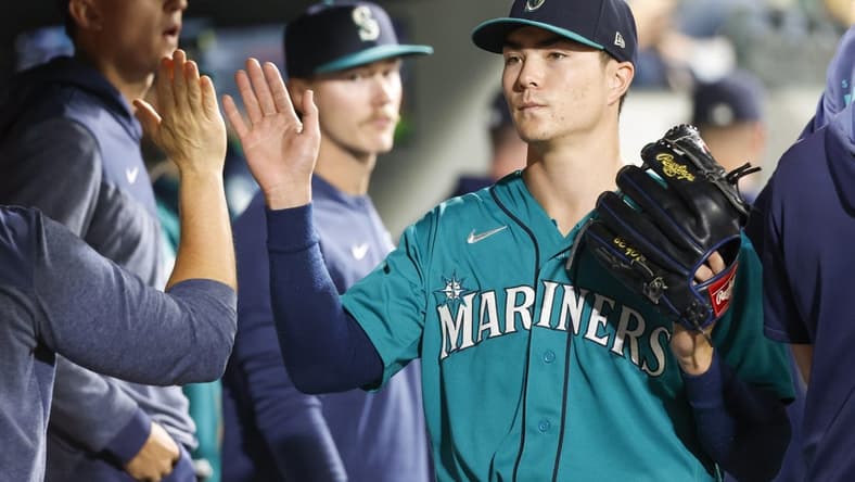 Sep 12, 2023; Seattle, Washington, USA; Seattle Mariners starting pitcher Bryan Woo (33) high-fives teammates and staff in the dugout during a sixth inning pitching change against the Los Angeles Angels at T-Mobile Park. Mandatory Credit: Joe Nicholson-USA TODAY Sports