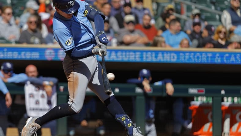 Sep 13, 2023; Minneapolis, Minnesota, USA; Tampa Bay Rays third baseman Curtis Mead (25) hits an RBI double against the Minnesota Twins in the third inning at Target Field. Mandatory Credit: Bruce Kluckhohn-USA TODAY Sports