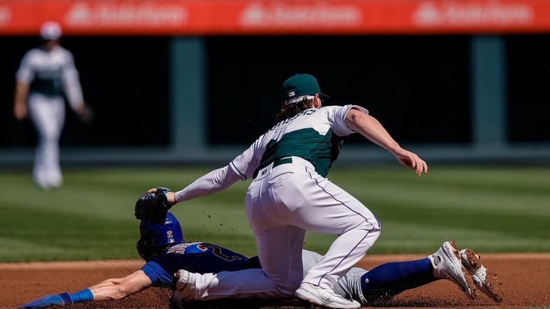Sep 13, 2023; Denver, Colorado, USA; Chicago Cubs second baseman Nico Hoerner (2) is tagged out attempting to steal second against Colorado Rockies second baseman Brendan Rodgers (7) in the first inning at Coors Field. Mandatory Credit: Isaiah J. Downing-USA TODAY Sports
