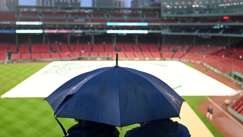 Sep 13, 2023; Boston, Massachusetts, USA; Fans wait in the rain before a game between the New York Yankees and the Boston Red Sox at Fenway Park. Mandatory Credit: Brian Fluharty-USA TODAY Sports