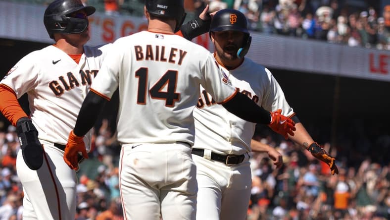 Sep 13, 2023; San Francisco, California, USA; San Francisco Giants third baseman J.D. Davis (7) is congratulated after hitting a three run home run during the eighth inning against the Cleveland Guardians at Oracle Park. Mandatory Credit: Sergio Estrada-USA TODAY Sports