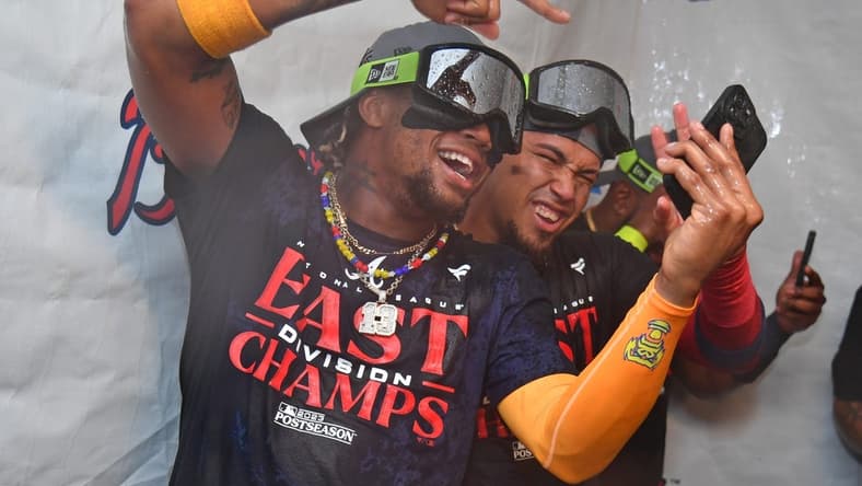 Sep 13, 2023; Philadelphia, Pennsylvania, USA; Atlanta Braves right fielder Ronald Acuna Jr. (13) and shortstop Orlando Arcia (11) celebrate their 6th straight National League East title in the locker room after win against the Philadelphia Phillies at Citizens Bank Park. Mandatory Credit: Eric Hartline-USA TODAY Sports