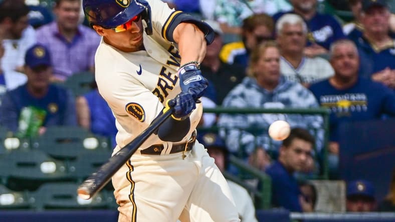 Sep 14, 2023; Milwaukee, Wisconsin, USA; Milwaukee Brewers left fielder Tyrone Taylor (15) hits a double to drive in a run in the seventh inning against the Miami Marlins at American Family Field. Mandatory Credit: Benny Sieu-USA TODAY Sports