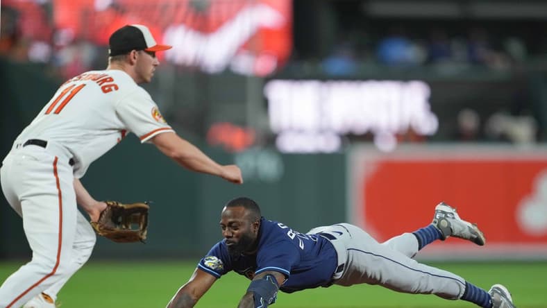 Sep 14, 2023; Baltimore, Maryland, USA; Tampa Bay Rays outfielder Randy Arozarena (56) slides in safely with a triple driving in two runs in the third inning against the Baltimore Orioles at Oriole Park at Camden Yards. Mandatory Credit: Mitch Stringer-USA TODAY Sports