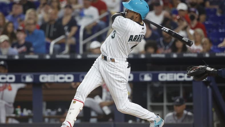 Sep 15, 2023; Miami, Florida, USA; Miami Marlins second baseman Luis Arraez (3) hits a home run against the Atlanta Braves during the first inning at loan Depot Park. Mandatory Credit: Rhona Wise-USA TODAY Sports