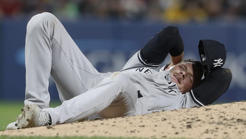 Sep 15, 2023; Pittsburgh, Pennsylvania, USA;  New York Yankees relief pitcher Anthony Misiewicz (54) reacts after being hit in the head by a line drive off the bat of Pittsburgh Pirates second baseman Ji Hwan Bae (not pictured) during the sixth inning at PNC Park. Misiewicz would leave the game.Mandatory Credit: Charles LeClaire-USA TODAY Sports