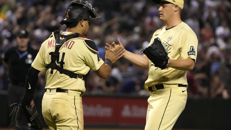 Sep 15, 2023; Phoenix, Arizona, USA; Arizona Diamondbacks catcher Gabriel Moreno (14) and pitcher Paul Sewald (38) celebrate after defeating the Chicago Cubs at Chase Field. Mandatory Credit: Rick Scuteri-USA TODAY Sports
