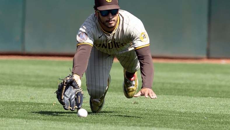 Sep 16, 2023; Oakland, California, USA; San Diego Padres center fielder Trent Grisham (1) misses a catch hit by Oakland Athletics center fielder Lawrence Butler during the fourth inning at Oakland-Alameda County Coliseum. Mandatory Credit: D. Ross Cameron-USA TODAY Sports