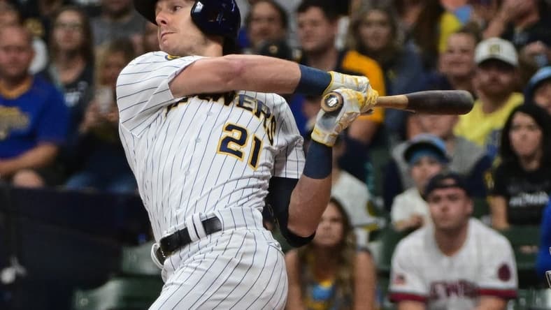 Sep 16, 2023; Milwaukee, Wisconsin, USA; Milwaukee Brewers left fielder Mark Canha (21) drives in a run with a base hit against the Washington Nationals in the first inning at American Family Field. Mandatory Credit: Benny Sieu-USA TODAY Sports