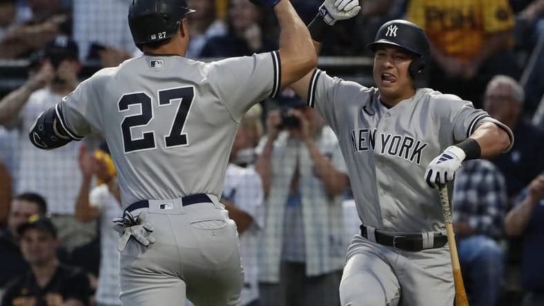 Sep 16, 2023; Pittsburgh, Pennsylvania, USA; New York Yankees shortstop Anthony Volpe (right) congratulates designated hitter Giancarlo Stanton (27) on his solo home run against the Pittsburgh Pirates during the third inning at PNC Park. Mandatory Credit: Charles LeClaire-USA TODAY Sports