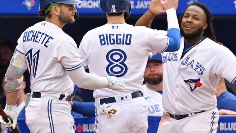Sep 16, 2023; Toronto, Ontario, CAN; Toronto Blue Jays pinch runner Cavan Biggio (8) celebrates with shortstop Bo Bichette (11) and first baseman Vladimir Guerrero Jr. (27) after scoring against the Boston Red Sox in the ninth inning at Rogers Centre. Mandatory Credit: Dan Hamilton-USA TODAY Sports