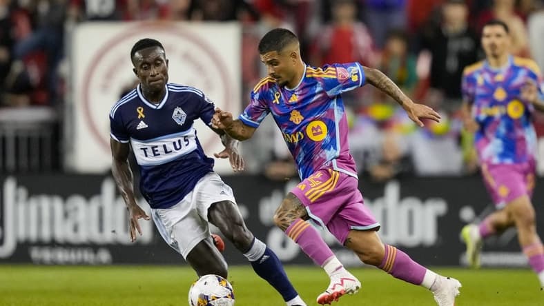 Sep 16, 2023; Toronto, Ontario, CAN; Toronto FC forward Lorenzo Insigne (24) moves the ball against Vancouver Whitecaps defender Richie Laryea (7) during the first half at BMO Field. Mandatory Credit: Kevin Sousa-USA TODAY Sports